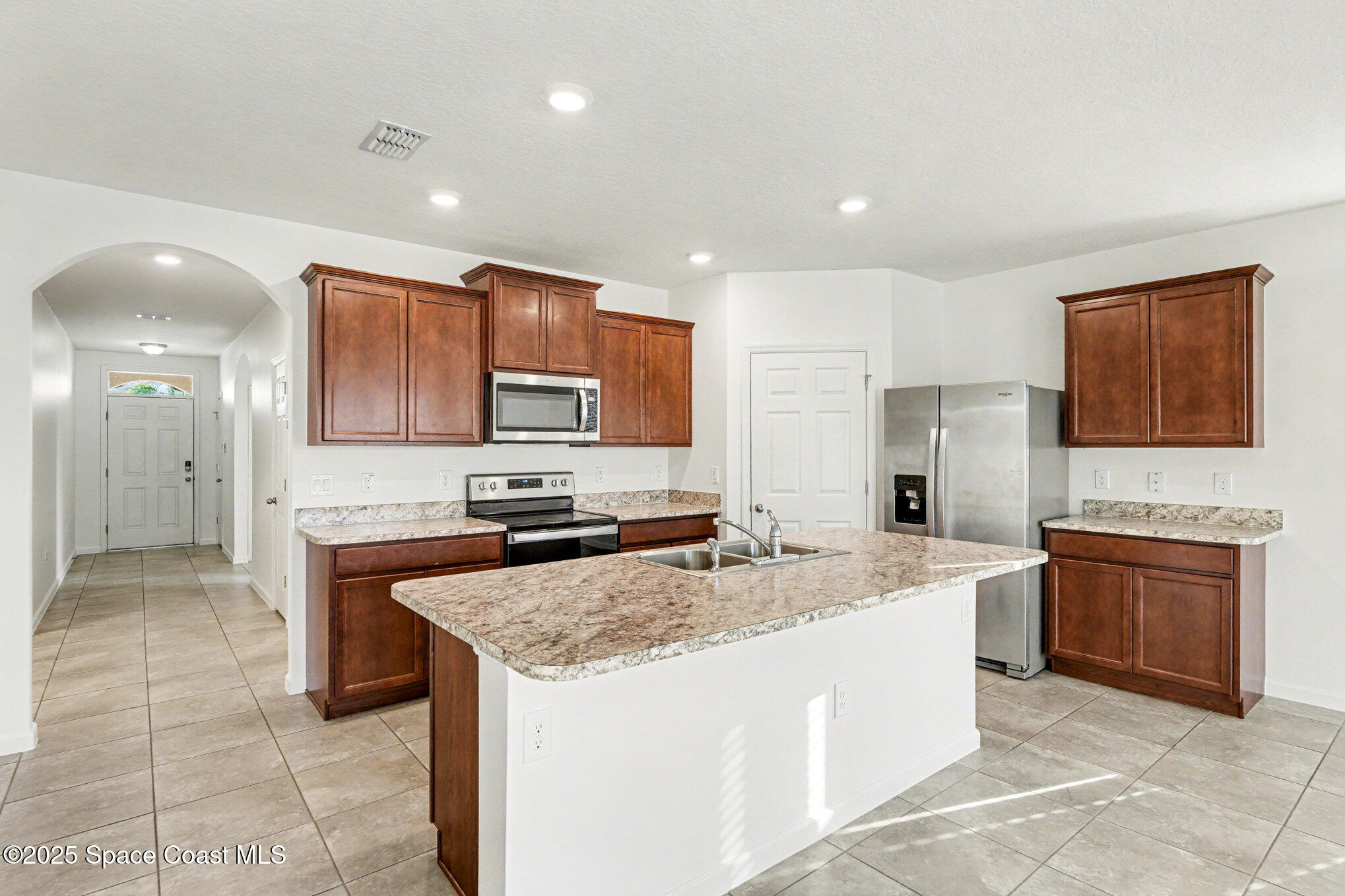 4604 Magenta Isles Drive Melbourne, FL 32904 - Photo 8 of 17 a kitchen with stainless steel appliances granite countertop a sink stove and refrigerator
