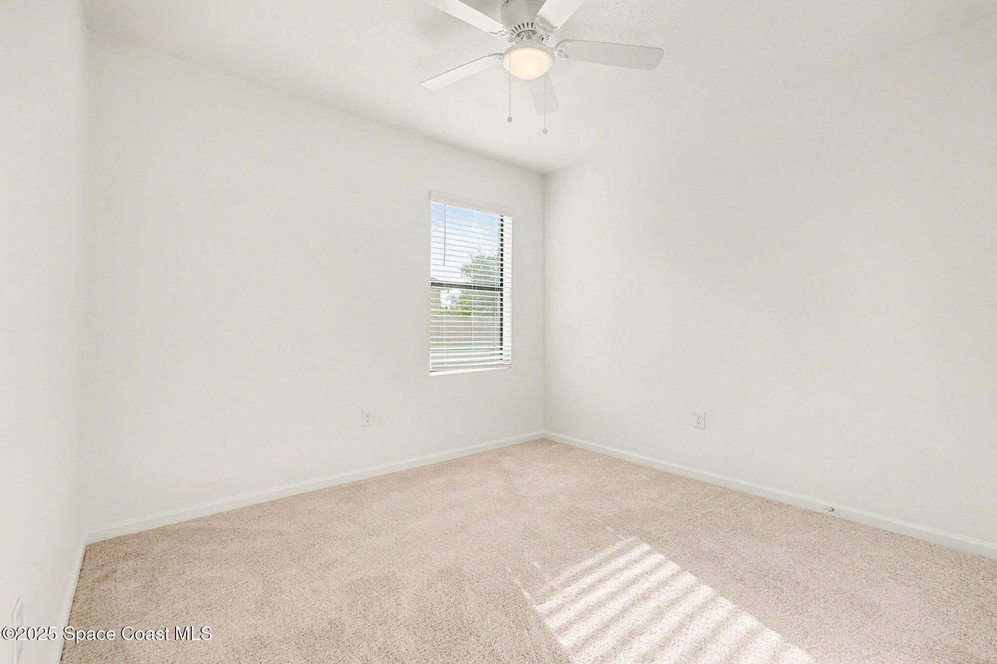 4604 Magenta Isles Drive Melbourne, FL 32904 - Photo 10 of 17 an empty room with a window and a fan