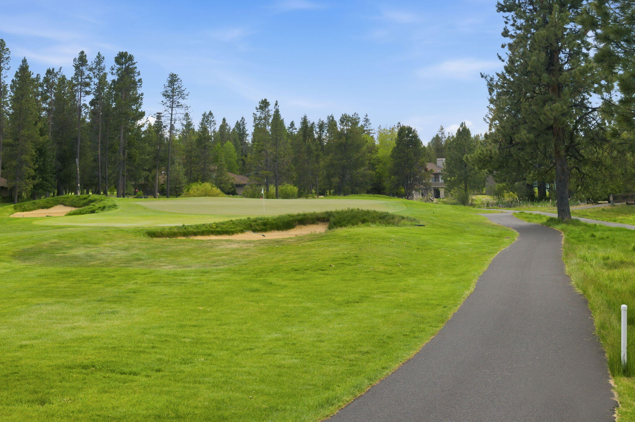 17654 Pinnacle Lane, Unit 16 Sunriver, OR 97707 - Photo 23 of 28 a view of a grassy field with trees in the background