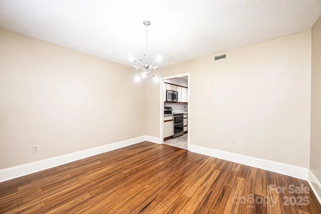 a view of a room with wooden floor and staircase
