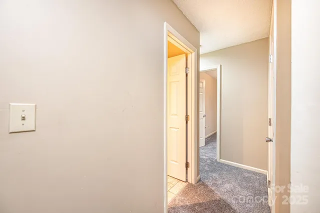 a view of bathroom with shower and a window