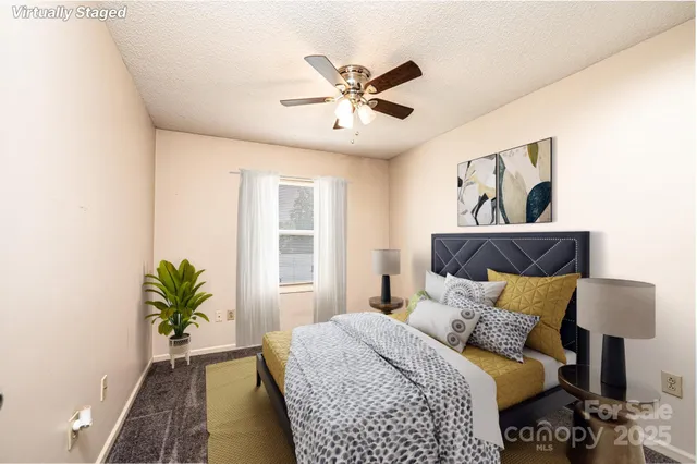 a bedroom with a bed and a painting on the wall