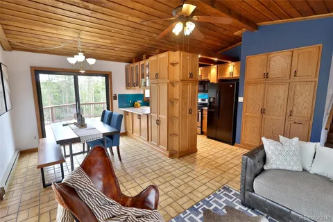 a living room with furniture a flat screen tv and a table