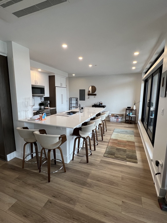 1950 Washington Street, Unit 5C Boston, MA 02118 - Photo 2 of 11 a large kitchen with a table and chairs in it