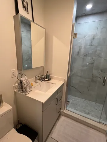 a bathroom with a sink toilet and shower