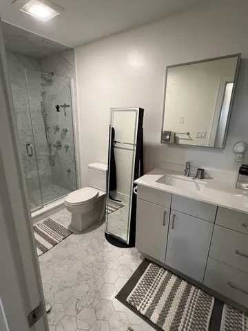 a bathroom with a sink toilet and shower