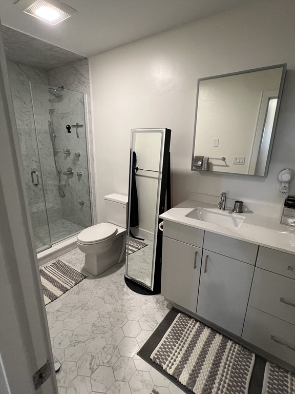 1950 Washington Street, Unit 5C Boston, MA 02118 - Photo 6 of 11 a bathroom with a sink toilet and shower