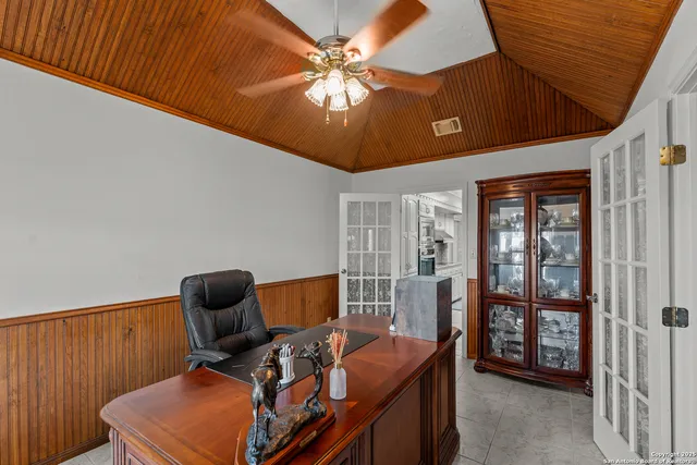 a room with furniture and fan