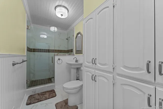 a bathroom with a toilet a sink and shower