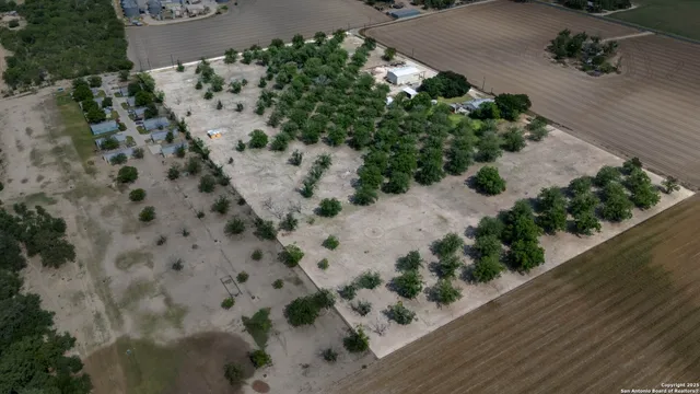 an aerial view of a house with a yard