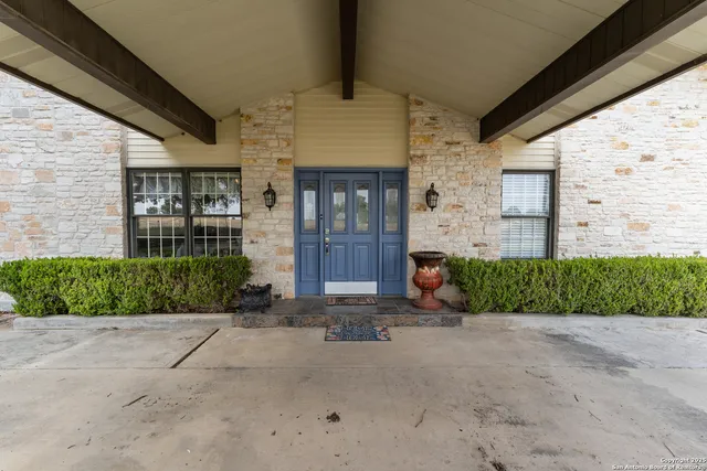 a front view of a brick house with a yard