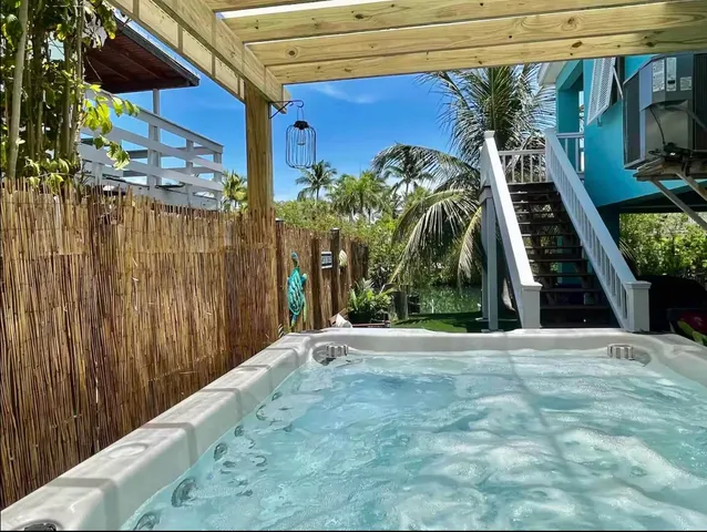 a outdoor space with a table and chairs and potted plants