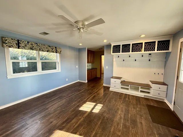 wooden floor in an empty room with a window