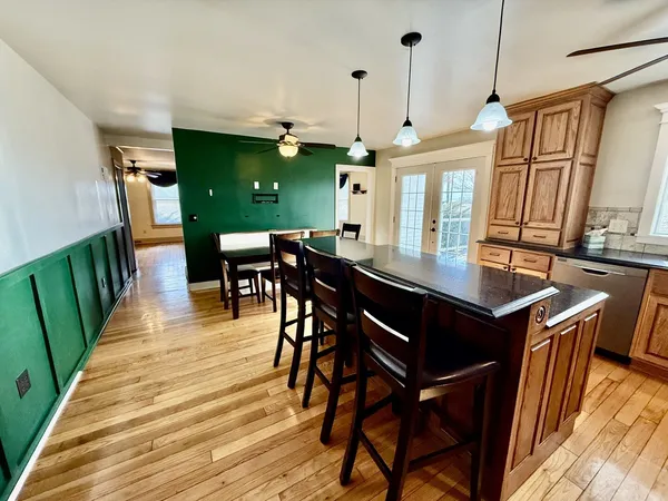 a view of a hallway with wooden floor and entryway