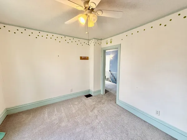 a view of a room with racks on the wall and a window