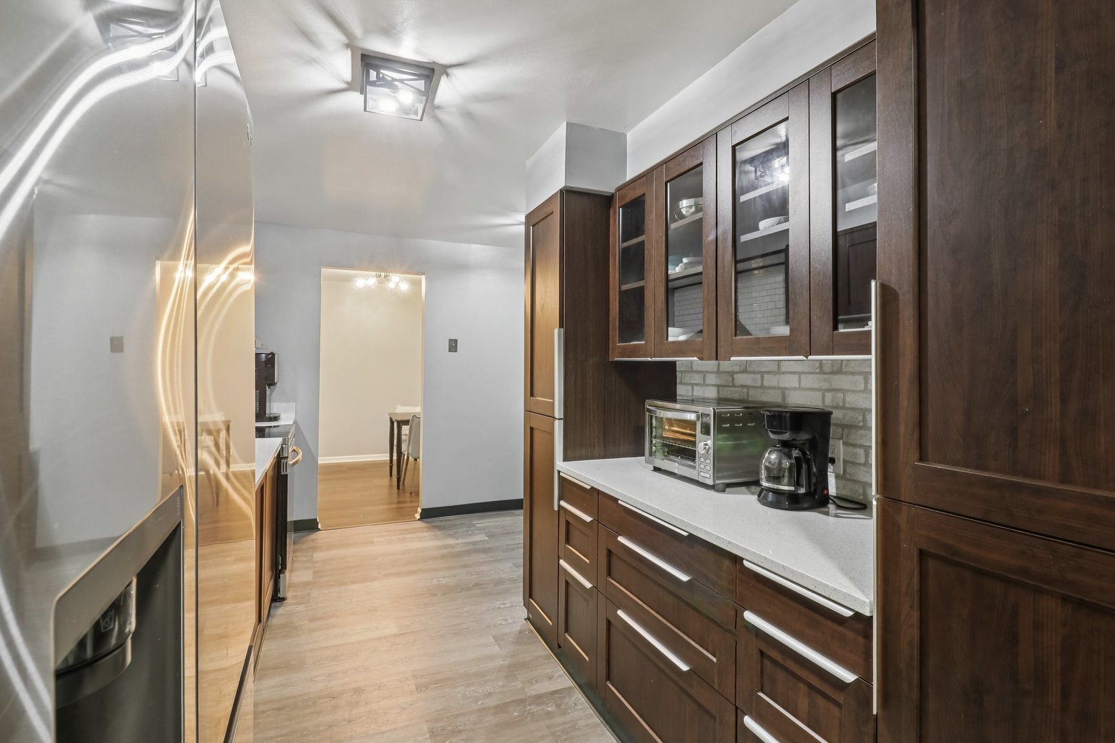 1405 East Central Road, Unit 122C Arlington Heights, IL 60005 - Photo 13 of 41 a kitchen with stainless steel appliances granite countertop cabinets and wooden floor