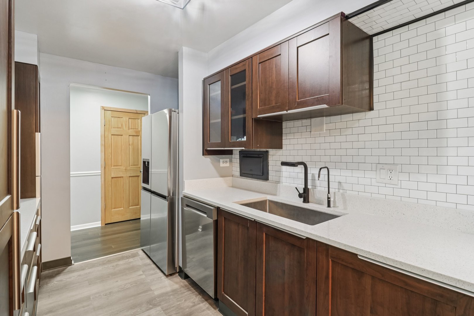 1405 East Central Road, Unit 122C Arlington Heights, IL 60005 - Photo 16 of 41 a kitchen with kitchen island granite countertop a sink stove and refrigerator