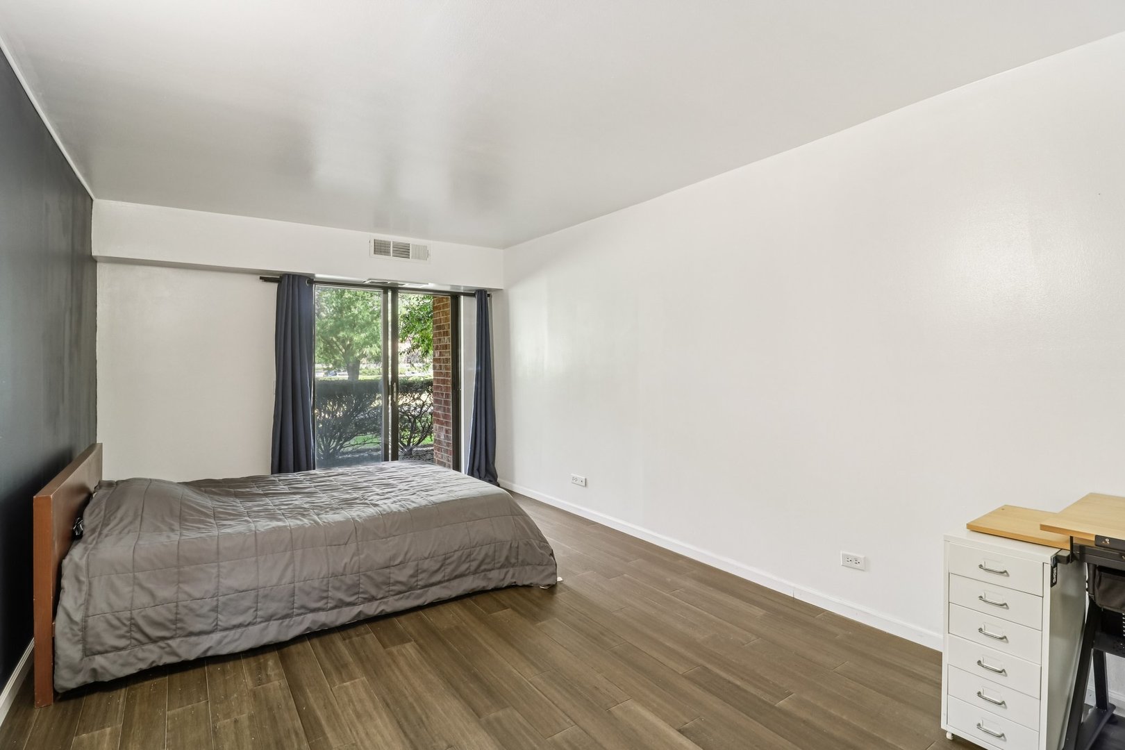 1405 East Central Road, Unit 122C Arlington Heights, IL 60005 - Photo 20 of 41 a bedroom with a bed and a window