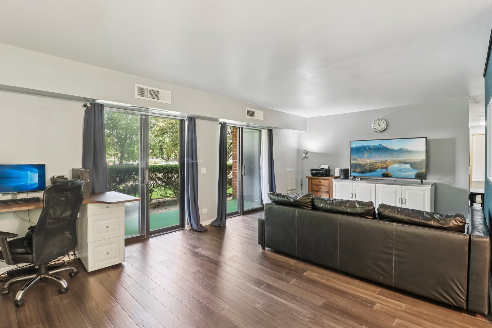 1405 East Central Road, Unit 122C Arlington Heights, IL 60005 - Photo 7 of 41 a living room with furniture and a wooden floor
