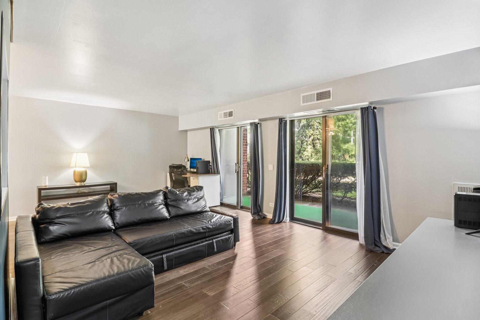 1405 East Central Road, Unit 122C Arlington Heights, IL 60005 - Photo 10 of 41 a living room with furniture and a large window