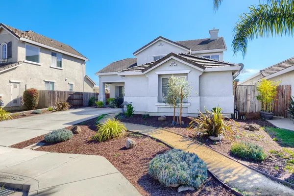 a front view of a house with garden