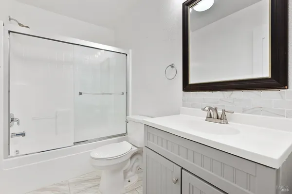 a front view of a house with a yard outdoor seating and mountain view