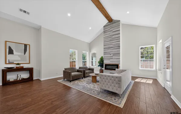 a view of a room with wooden floor and white walls