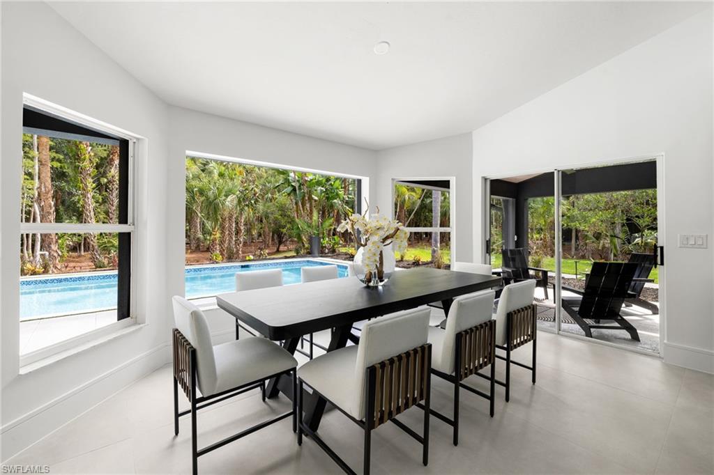 4521 3rd Avenue Northwest Naples, FL 34119 - Photo 11 of 46 a view of a dining room with furniture window and outside view