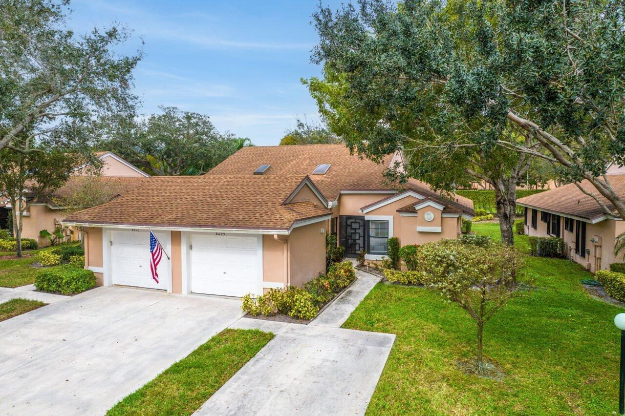 8299 Springlake Drive, Unit B Boca Raton, FL 33496 - Photo 1 of 31 a front view of a house with a garden and plants