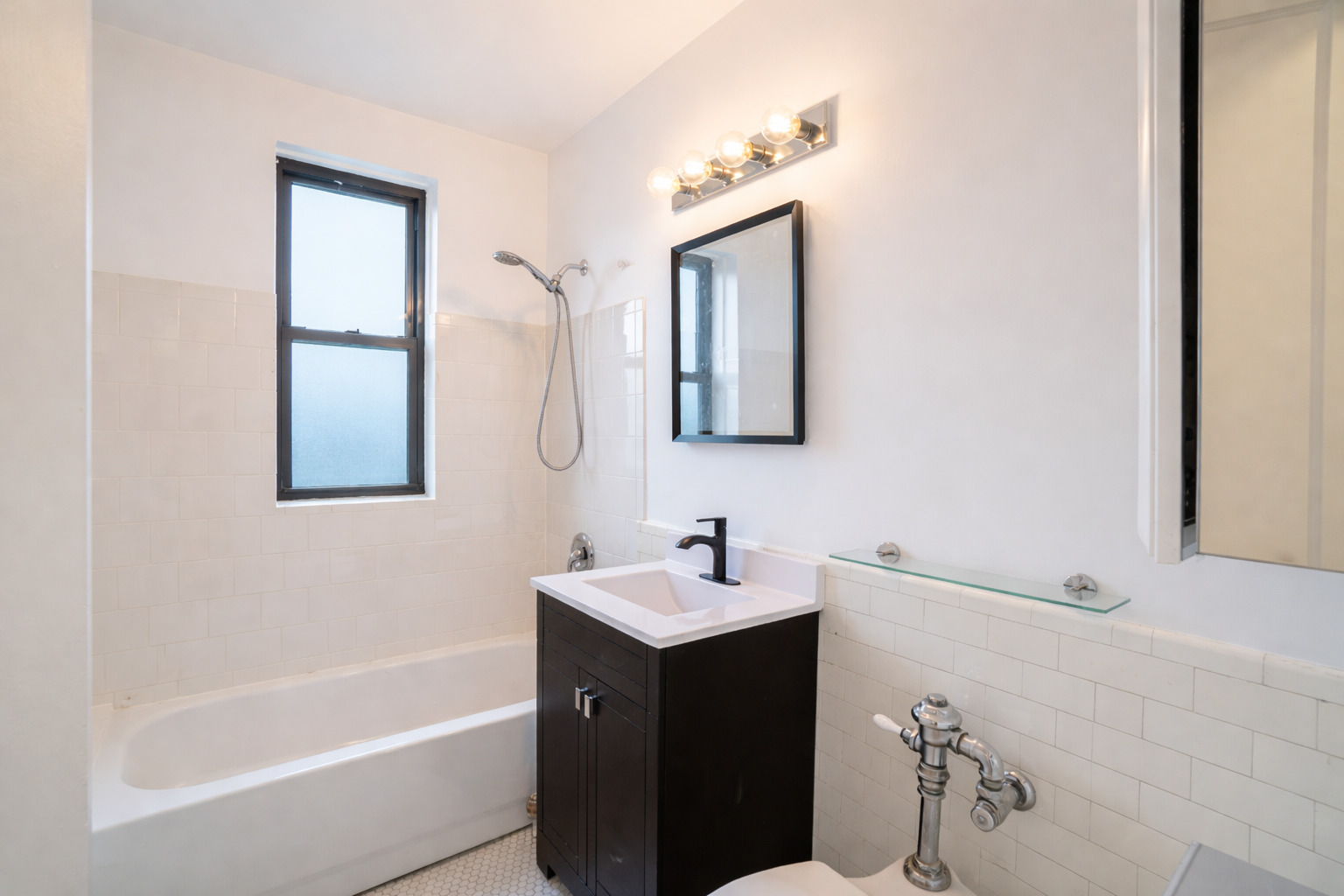 1765 East 55th Street, Unit E1 Chicago, IL 60637 - Photo 13 of 18 a bathroom with a bathtub sink and mirror