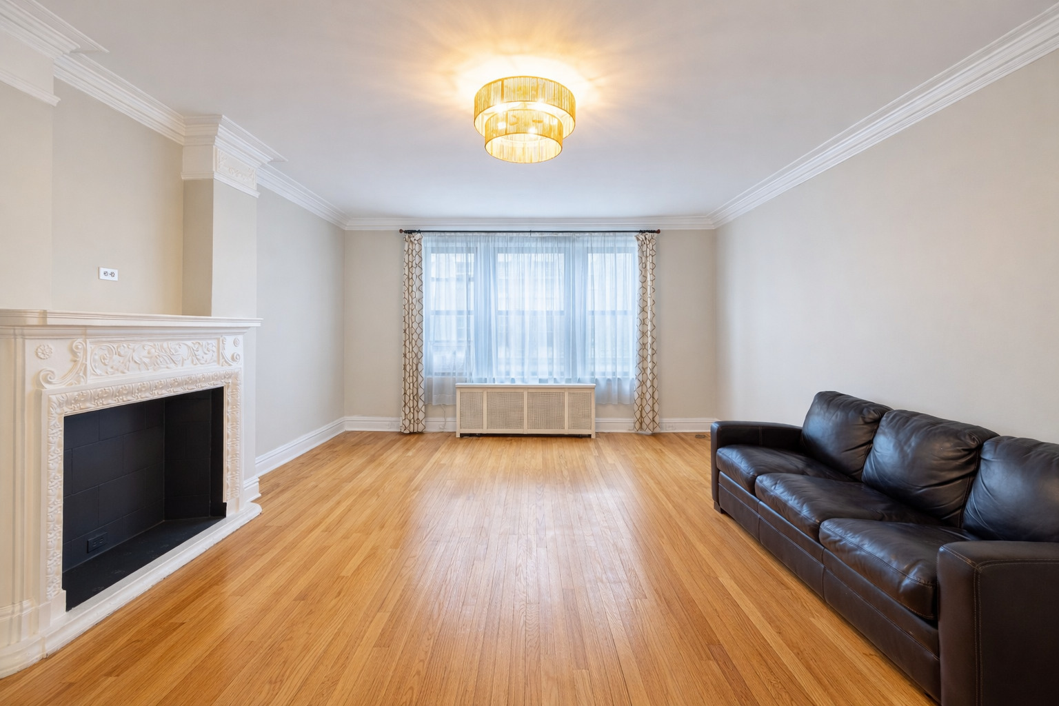 1765 East 55th Street, Unit E1 Chicago, IL 60637 - Photo 6 of 18 a view of livingroom with hardwood floor and a fireplace