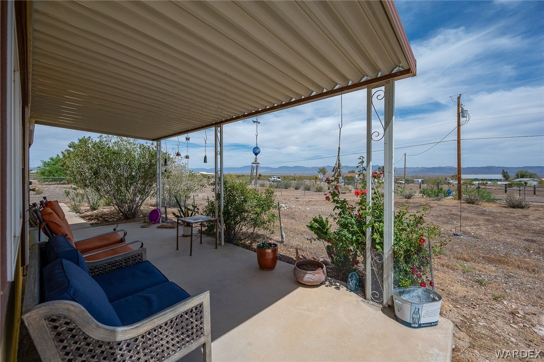 2465 Egar Road Golden Valley, AZ 86413 - Photo 7 of 98 Relaxing covered patio with a concrete floor, offering views of the surrounding natural landscape