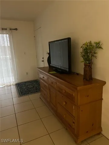 a living room with hard wood floor and a flat screen tv