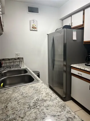 a bathroom with a sink and a refrigerator
