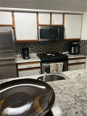 a kitchen with a sink and a microwave