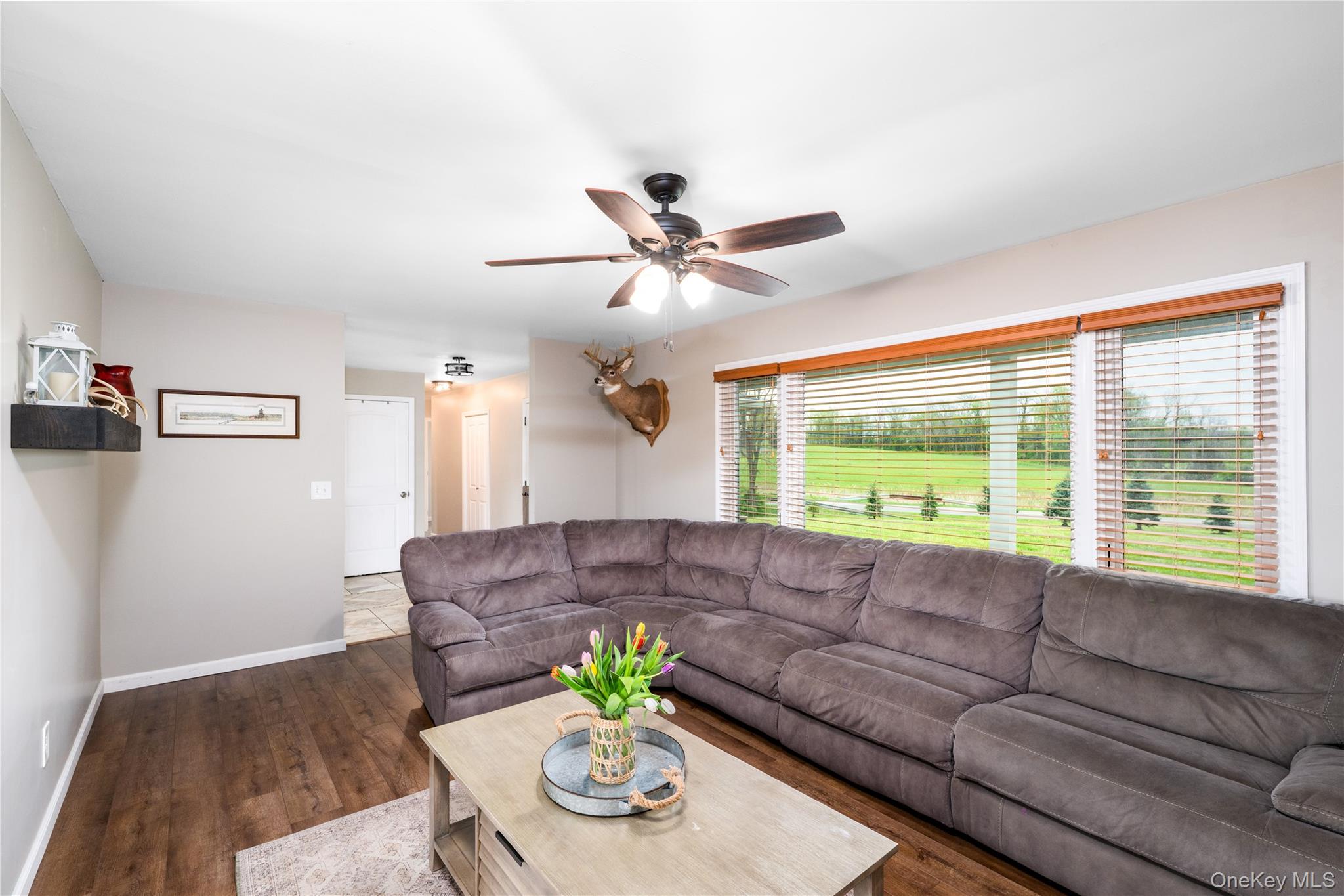 41 Diddell Road Wappingers Falls, NY 12590 - Photo 15 of 44 Spacious living area featuring wood flooring, a ceiling fan with integrated lighting, and neutral wall tones
