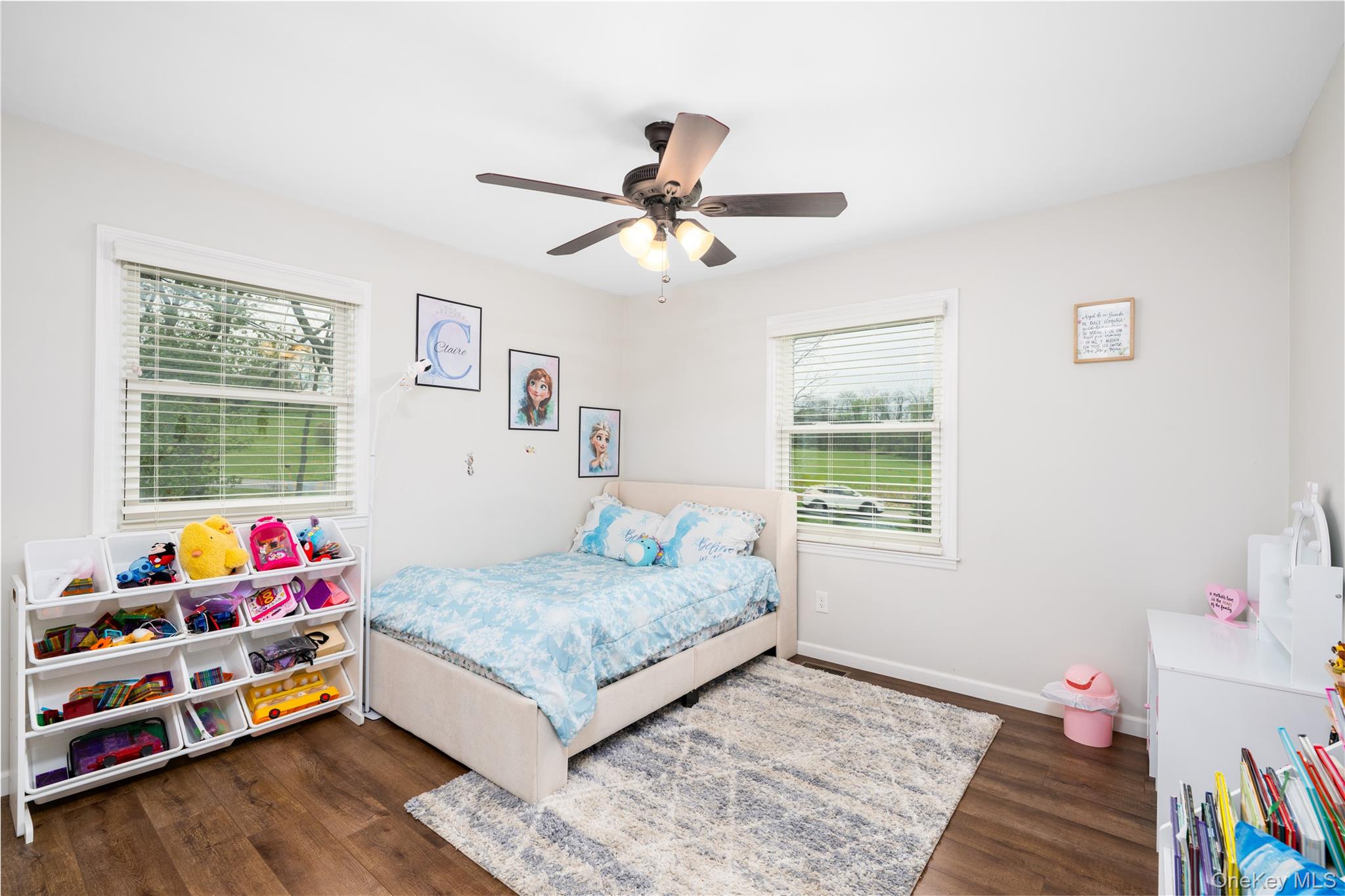 41 Diddell Road Wappingers Falls, NY 12590 - Photo 19 of 44 Bedroom 2- Light-filled, featuring wood flooring, two large windows with horizontal blinds, and a ceiling fan with integrated lighting