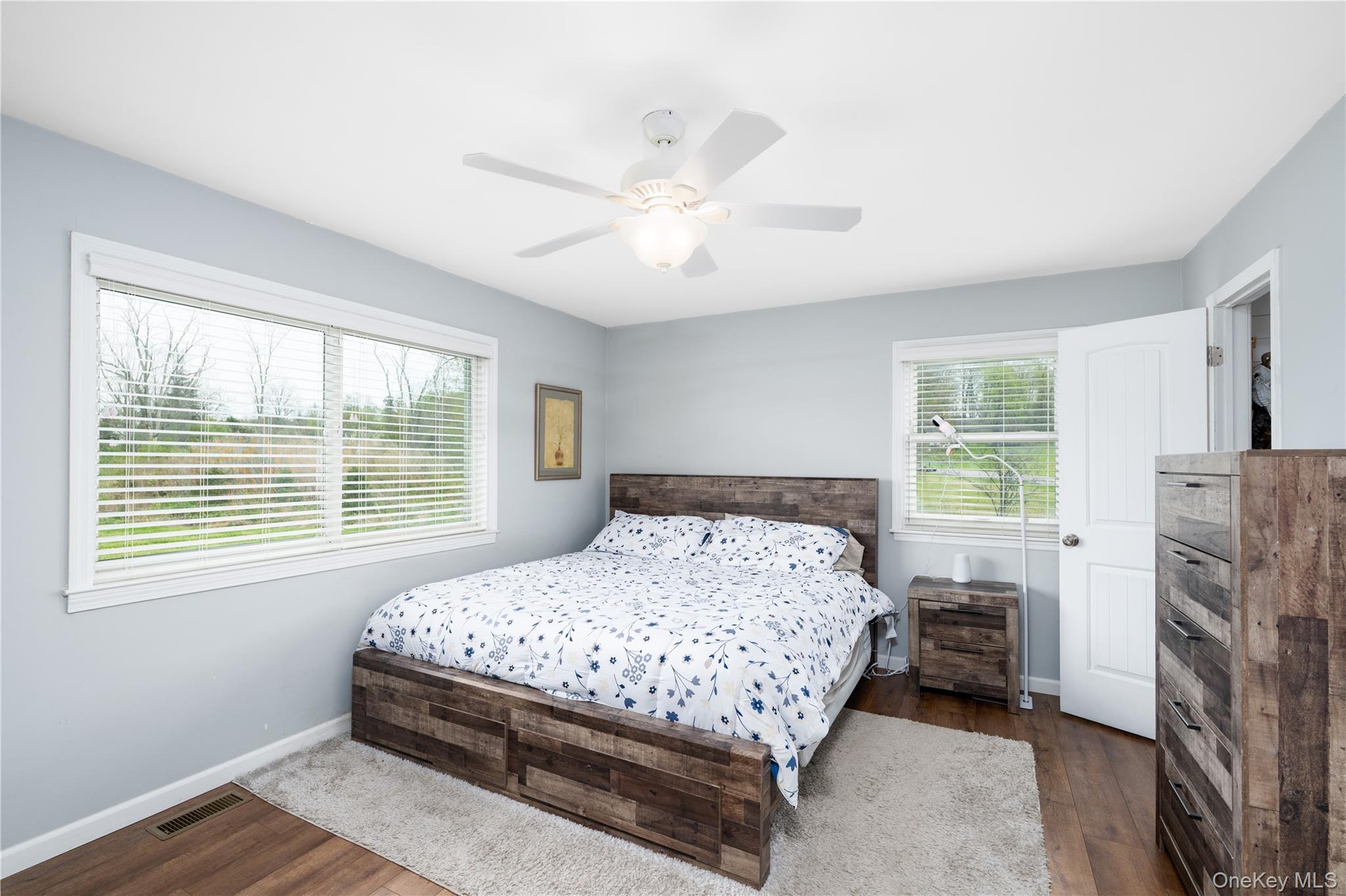 41 Diddell Road Wappingers Falls, NY 12590 - Photo 22 of 44 Spacious bedroom featuring light blue walls, wood flooring, and a white ceiling fan