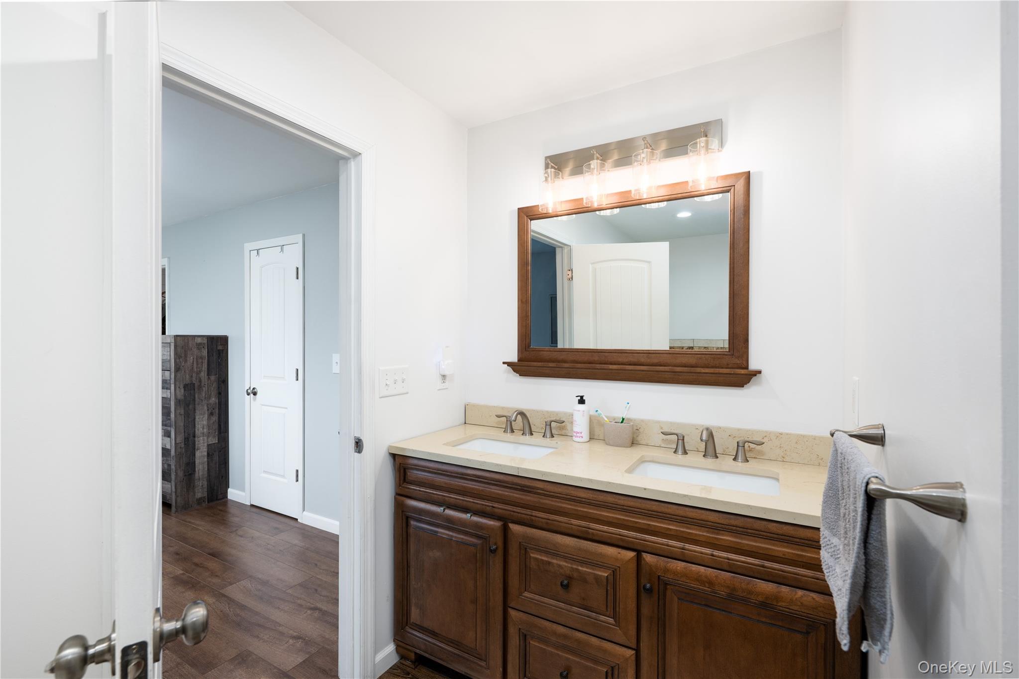 41 Diddell Road Wappingers Falls, NY 12590 - Photo 25 of 44 Ensuite Bathroom featuring a dual-sink Quartz vanity, a framed mirror, and a multi-bulb light fixture