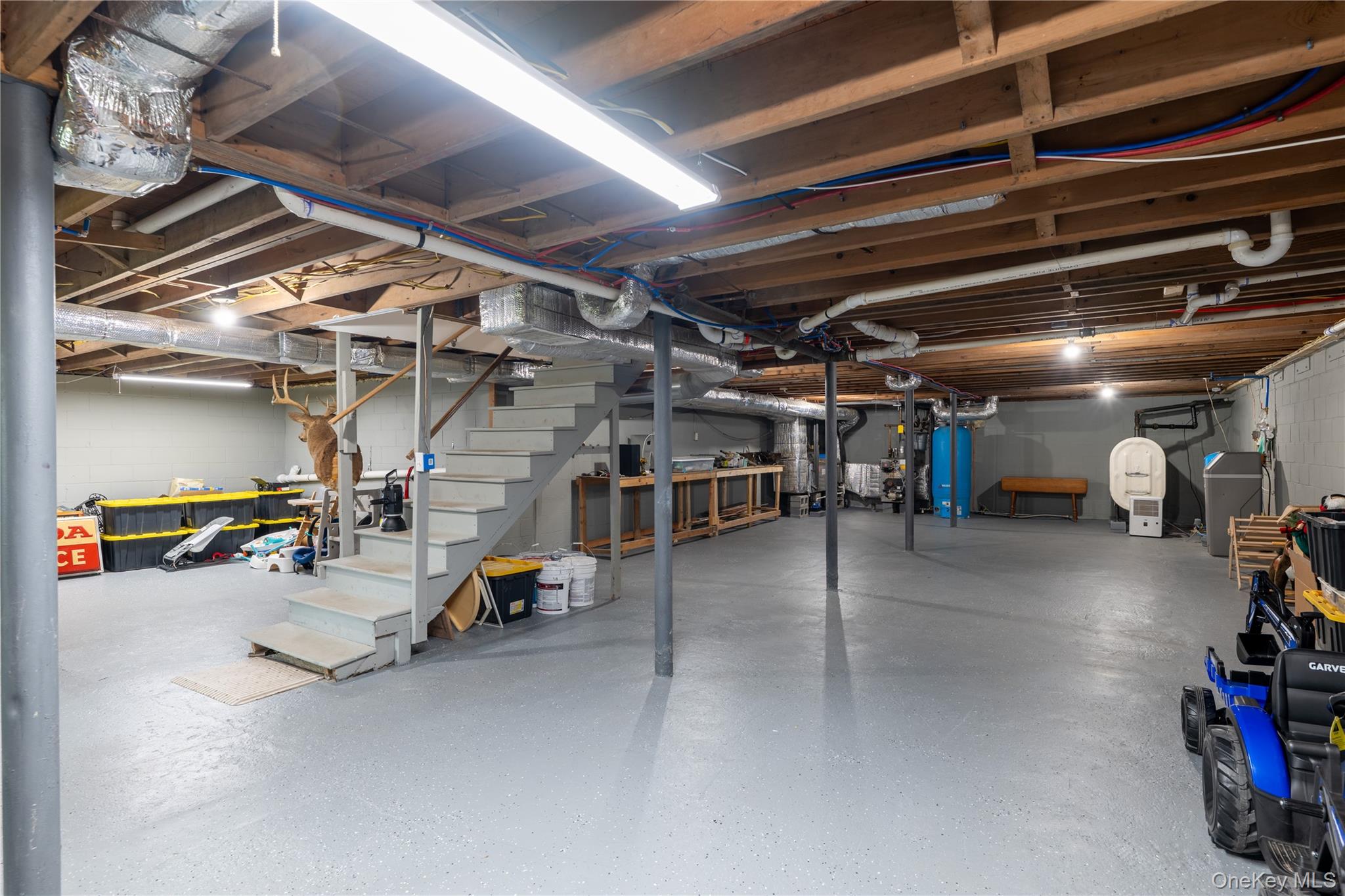41 Diddell Road Wappingers Falls, NY 12590 - Photo 26 of 44 Spacious unfinished basement with epoxy flooring, exposed ceiling joists, water heater, and water softener system