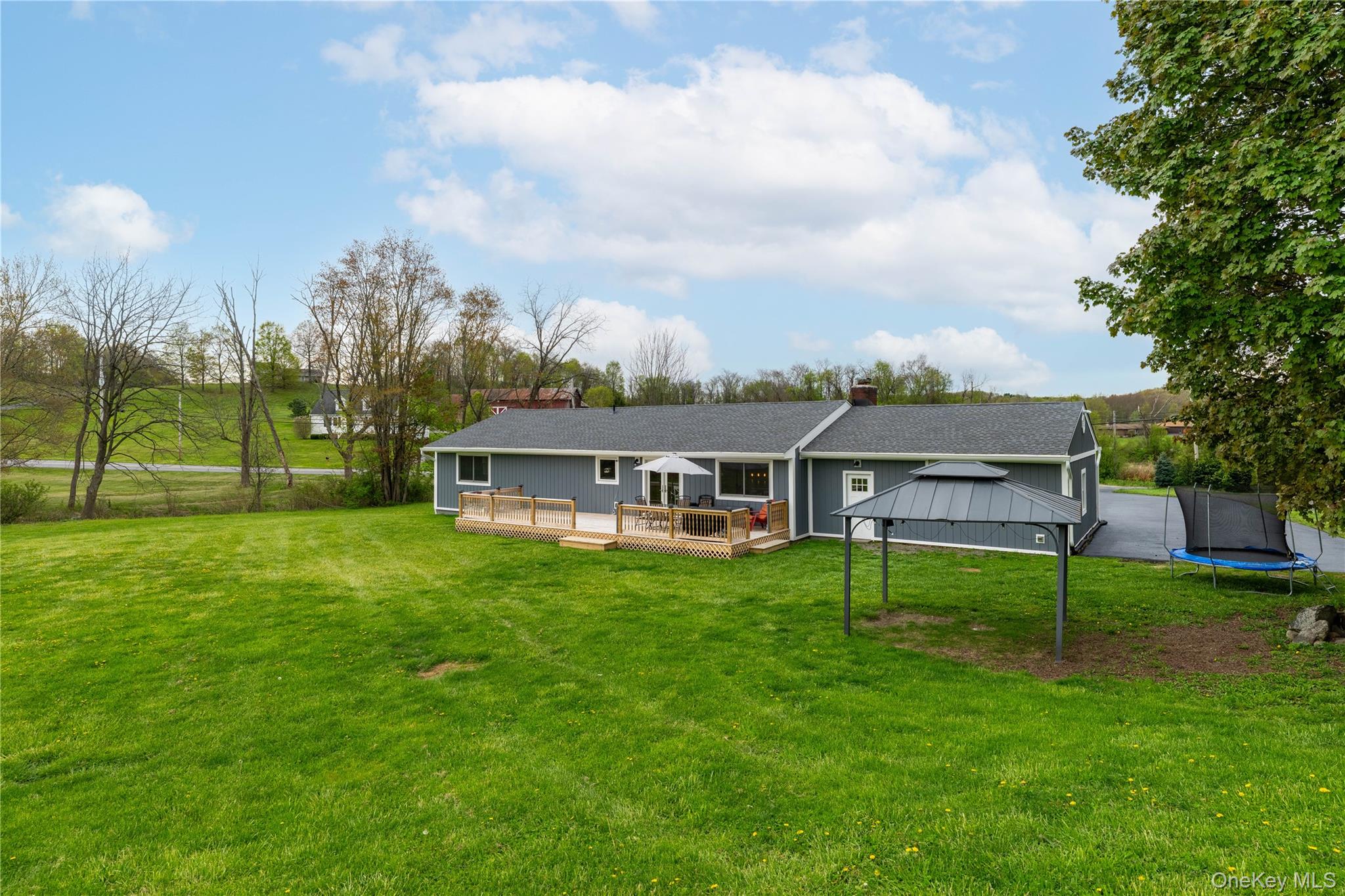 41 Diddell Road Wappingers Falls, NY 12590 - Photo 7 of 44 Expansive green lawn surrounds the property, featuring a wood deck