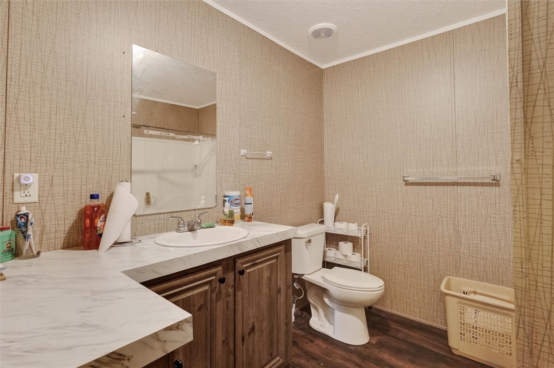 1926 Fairview Road Peebles, OH 45660 - Photo 33 of 44 This bathroom features a sleek vanity, convenient toilet, and rich flooring.