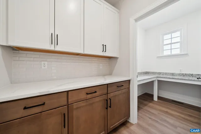 a living room with furniture a fireplace and a table