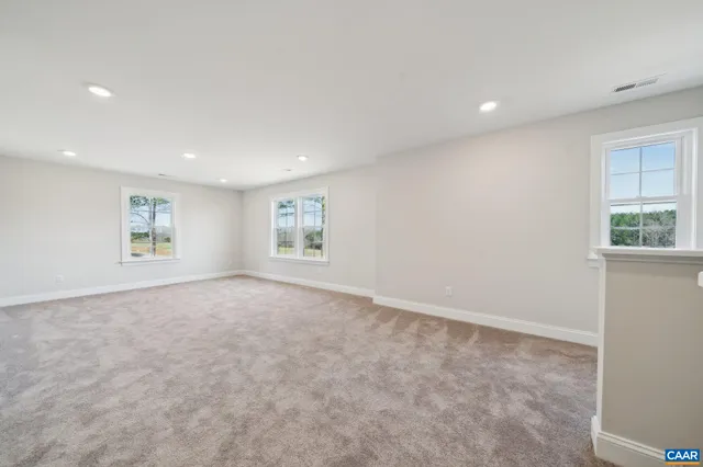 an empty room with a bathroom and a sink