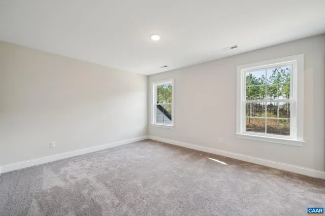 an aerial view of residential houses with outdoor space and lake view