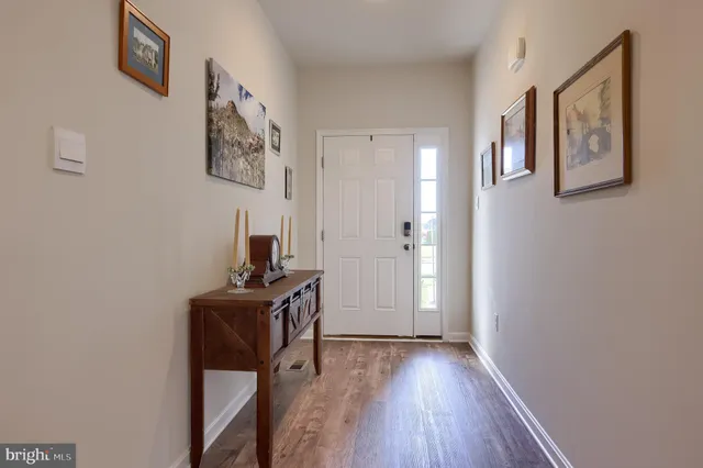 a view of a workspace with wooden floor and a window