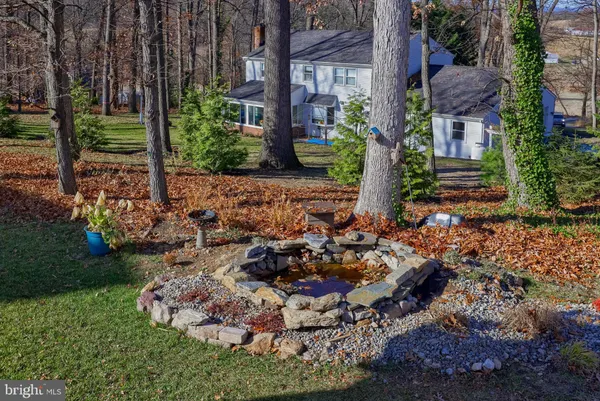 a view of a house with a garden and trees