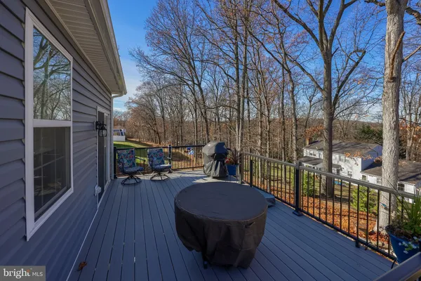 a view of a patio with table and chairs and wooden floor