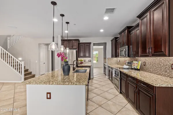 a view of a kitchen with a sink and cabinets