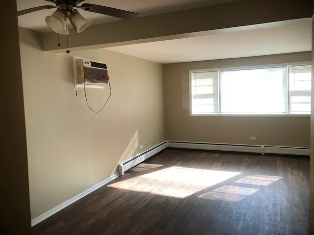 a view of a room with window and a ceiling fan